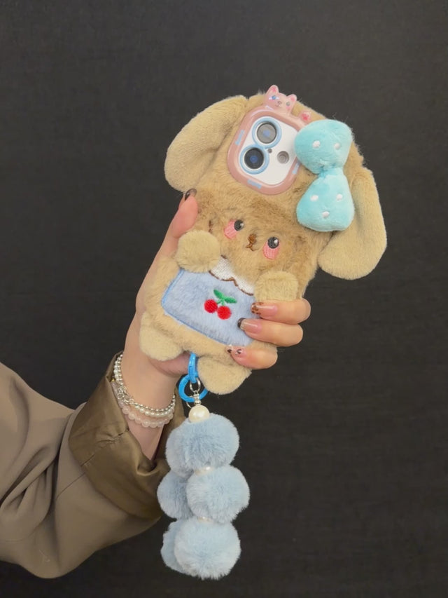 Plush Puppy Phone Case with Bow, Cherry Detail, and Blue Pom-Pom Bracelet